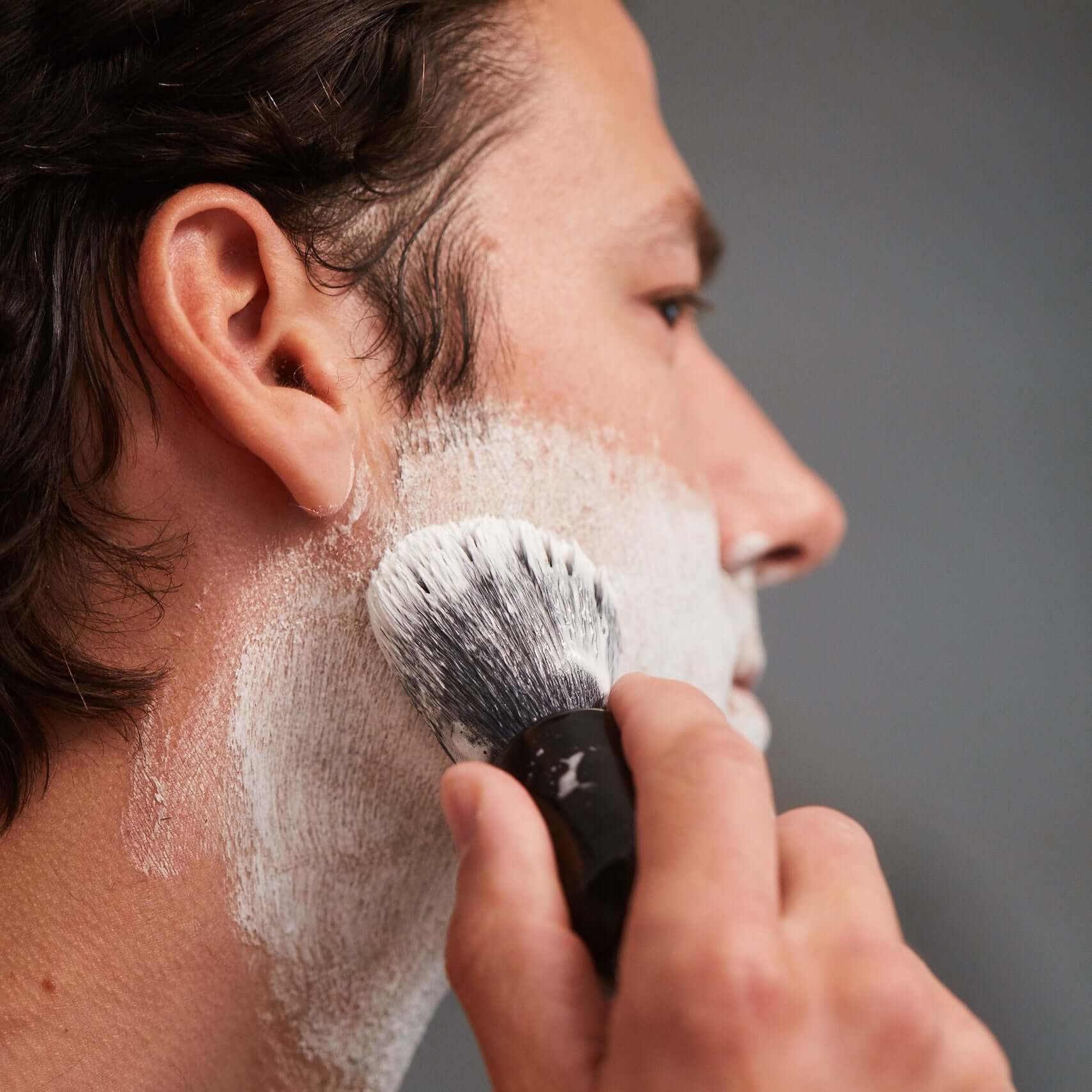 Man using OneBlade Shaving Brush to lather for Safety Razor Shave