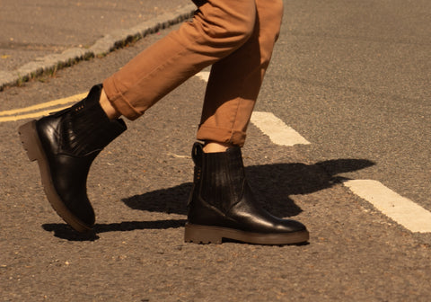 women walking with black chelsea boots