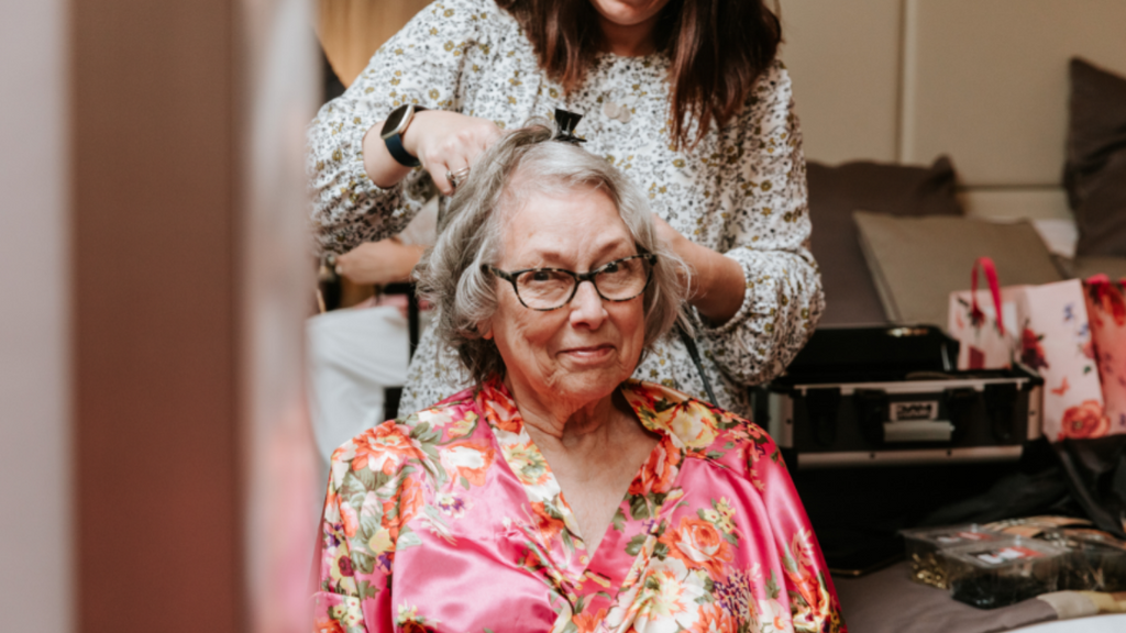 Jay doing my maternal grandmother’s hair. My Grammy was thrilled to have hair and makeup done on the day.