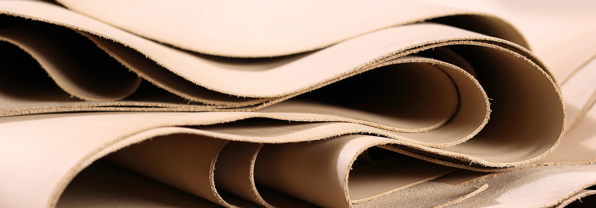 Close-up of folded beige leather sheets.