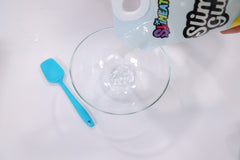 Pouring clear glue into a bowl