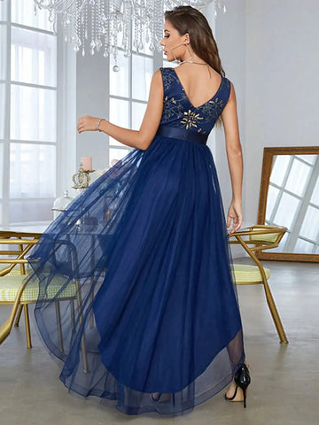 a lady posing in a asymmetrical blue bridesmaid dress