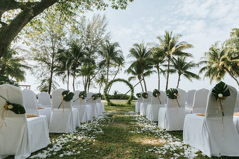 outdoor wedding location in a floral garden with white tables