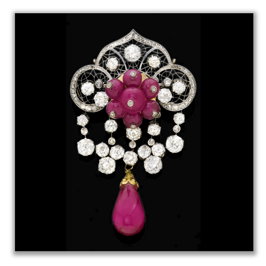 1910. A filigree brooch with central flower motif set with ruby