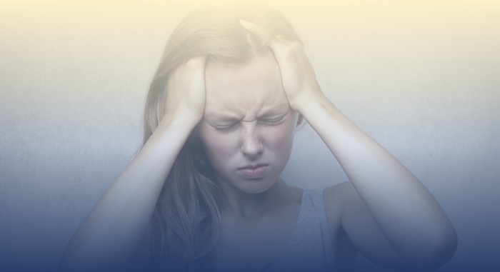 A woman with tired eyes, disheveled hair, and a weary expression, indicating sleep deprivation.