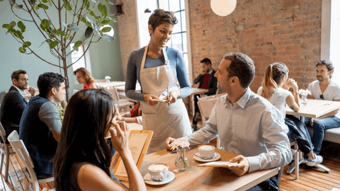Friendly waitress taking an order from a businessman in a Miami coffee shop, showcasing excellent customer service and a warm, inviting atmosphere ideal for entrepreneurs and digital nomads, central to a content-driven marketing strategy.