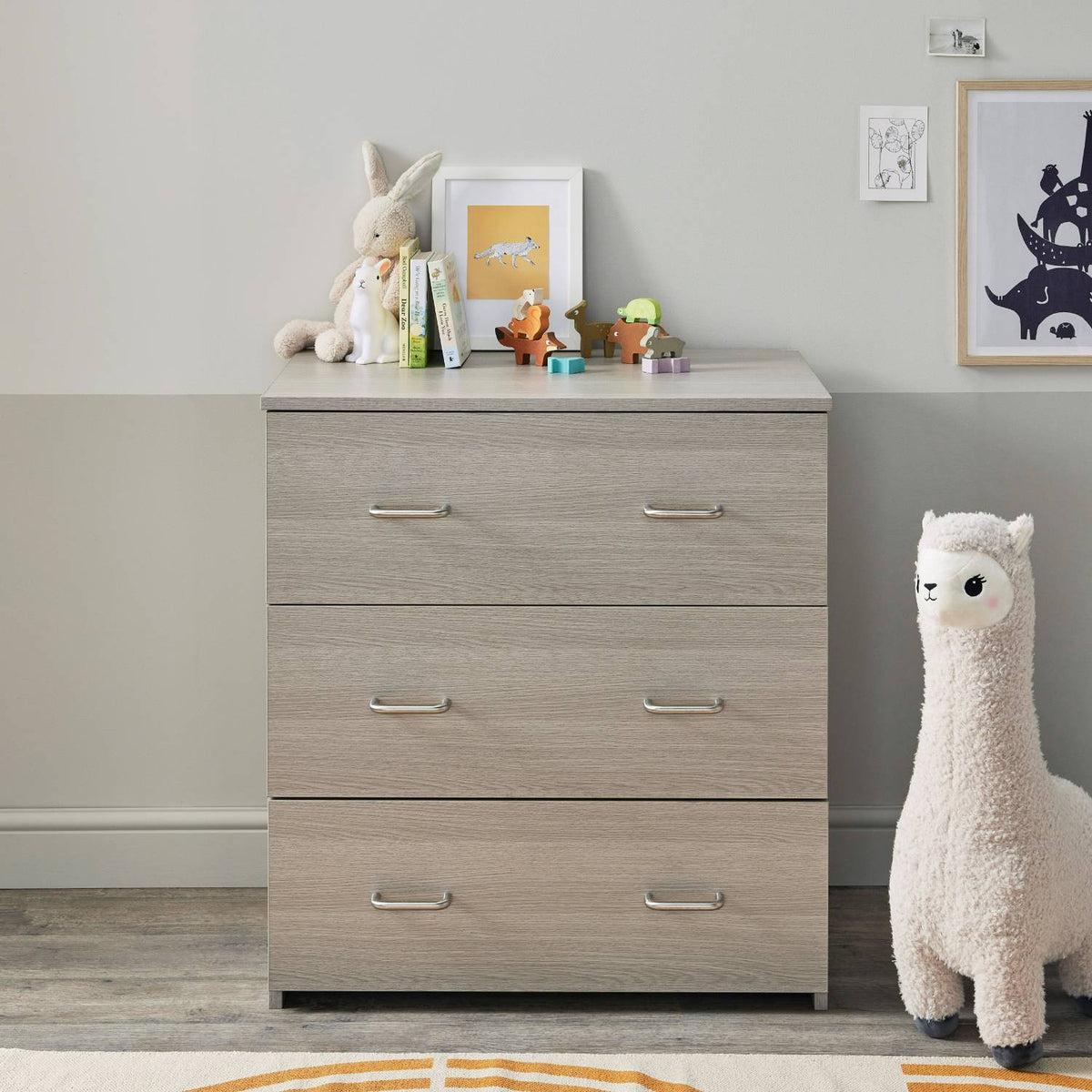 Babymore Caro Nursery Chest Changer in Grey Wash color with changer top removed and replaced with baby books