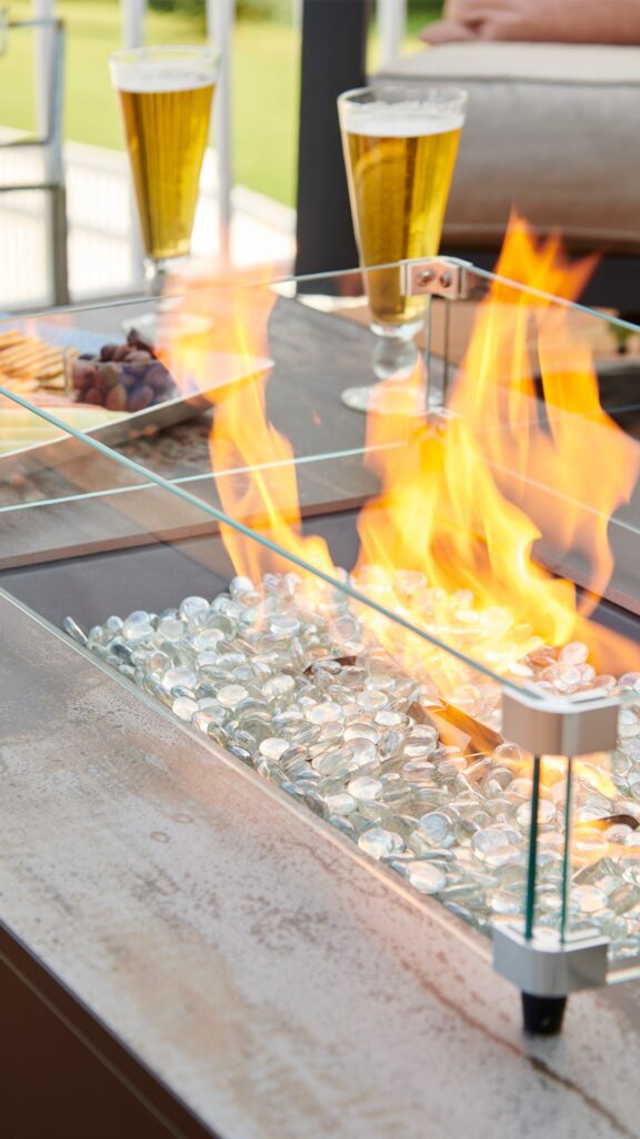 The Outdoor Greatroom Company offers a variety of fire pit rocks, wind guards and burners to keep your fire pit table working for years to come.¬†