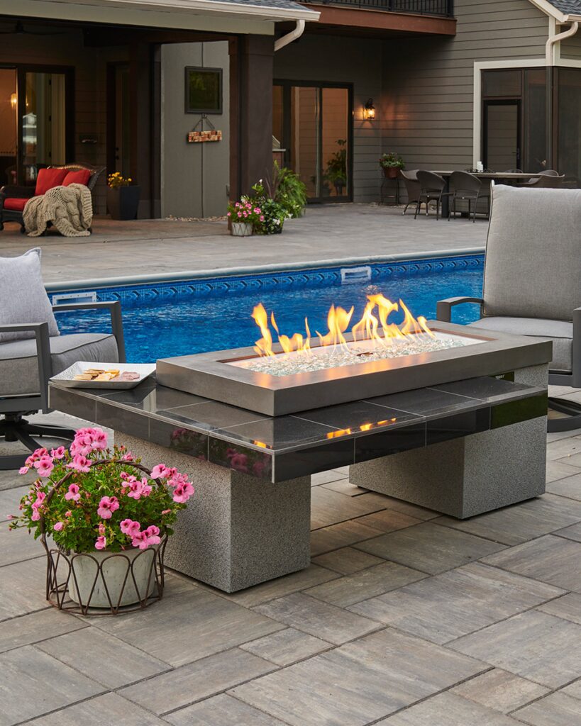 The Outdoor Greatroom Company's fire pit tables are great for entertaining and creating a focal point around a pool or other outdoor area.