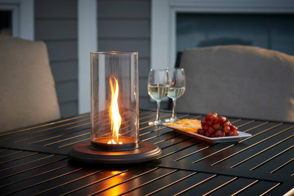 To make your outdoor kitchen a truly inviting space, consider adding lighting and entertainment features. An Intrigue Table Top Outdoor Lantern looks great on a table in your backyard.