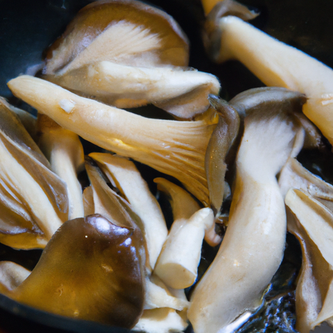 oyster mushrooms being sauted in a pan