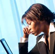 person gazing fixedly into a laptop screen