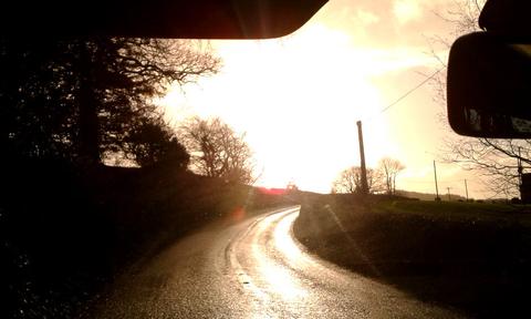 danger from sun reflected on wet road
