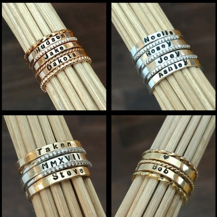 Stackable Name Rings - Nếu bạn muốn sở hữu một chiếc nhẫn tên đẹp mắt thì hãy xem hình ảnh này ngay. Những chiếc nhẫn tên có thể xếp chồng này mang tính thẩm mỹ cao và rất độc đáo. Hình ảnh cho thấy những chiếc nhẫn tên này đẹp tuyệt vời khi được đeo cùng nhau.