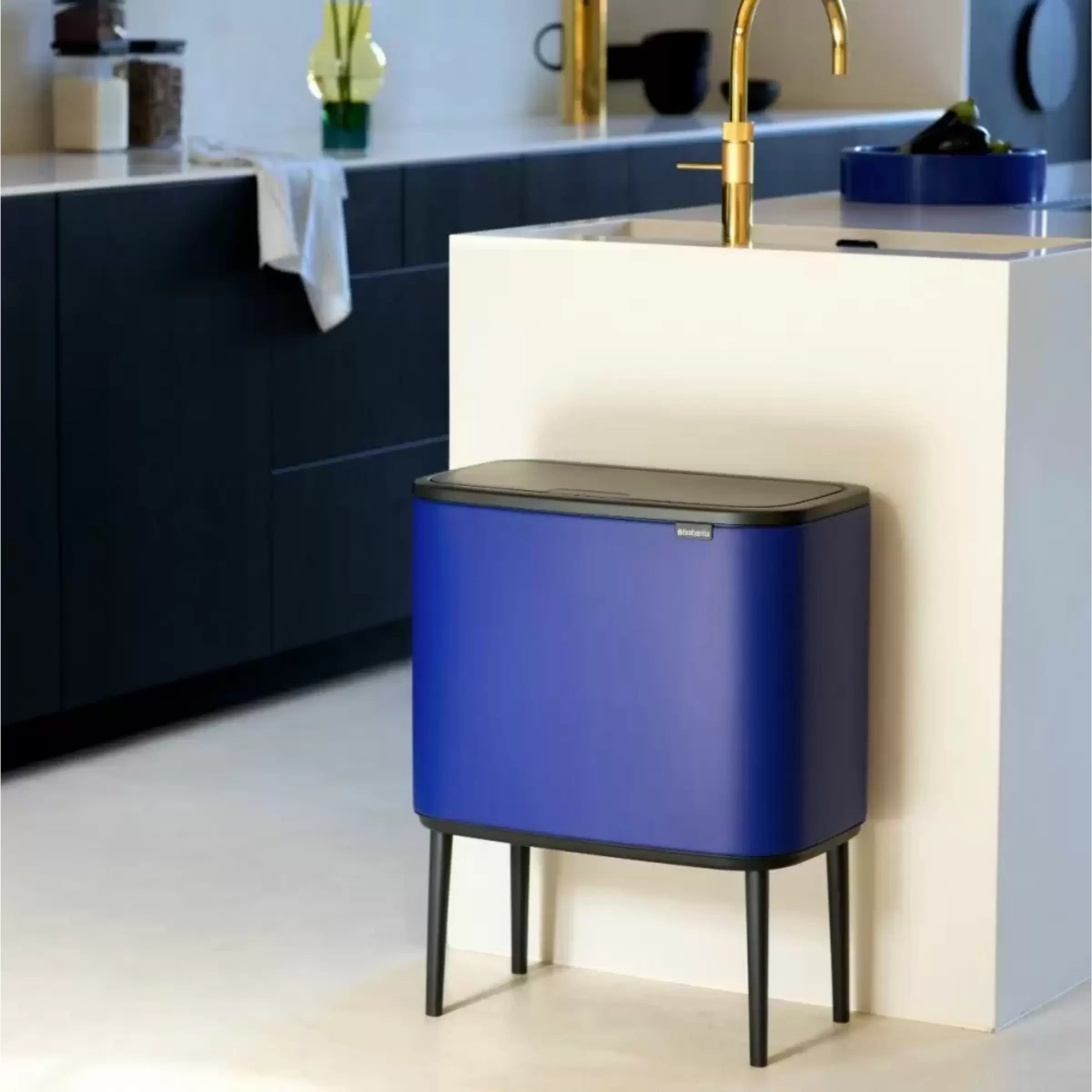 A blue Brabantia bin in a kitchen