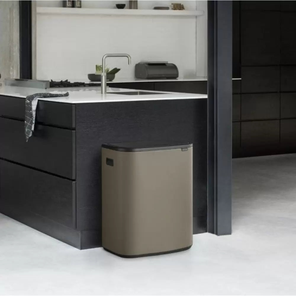 A Brabantia Bo Touch bin in a black kitchen