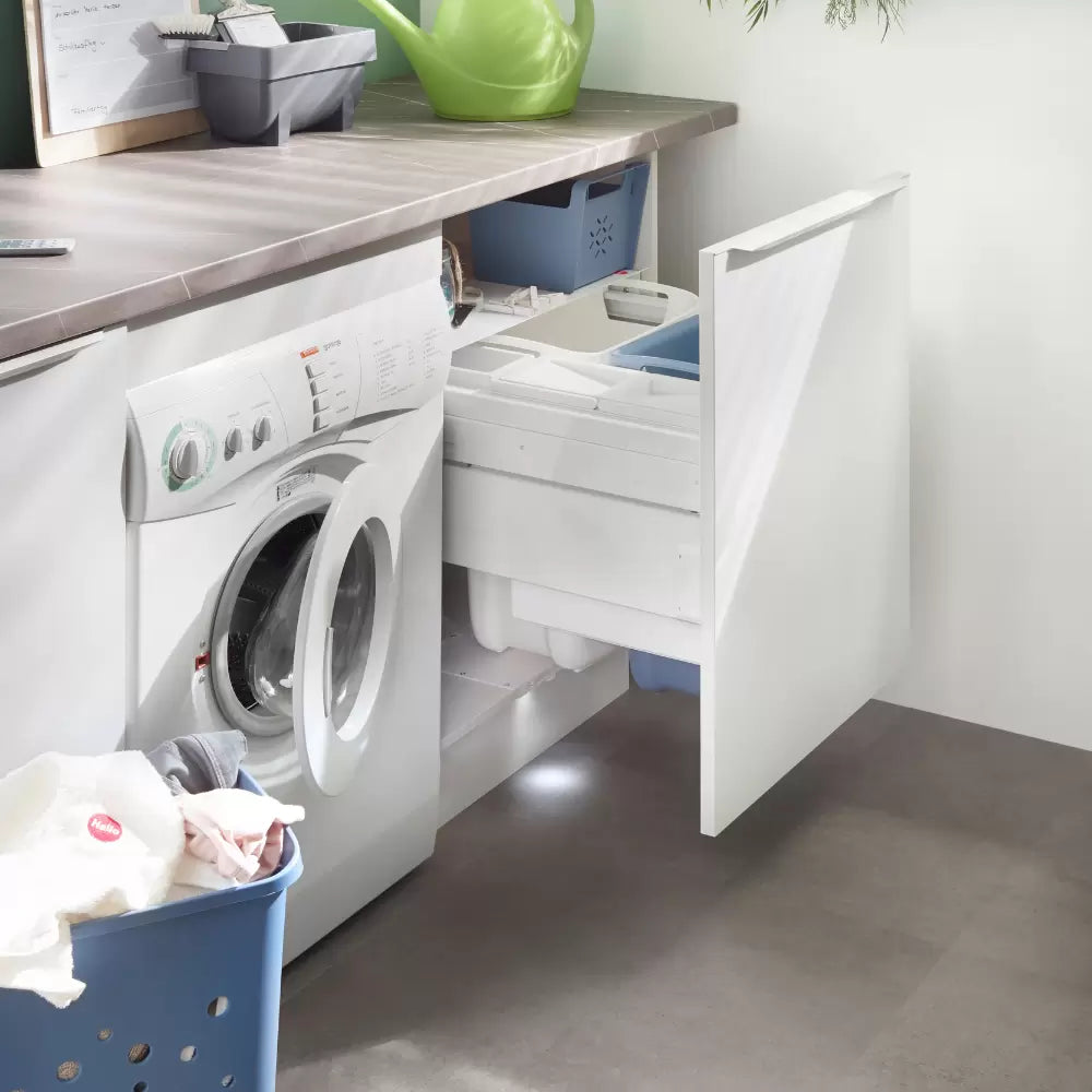 A utility room with an integrated laundry bin