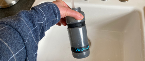 Water to Go water filter bottle being filled at sink