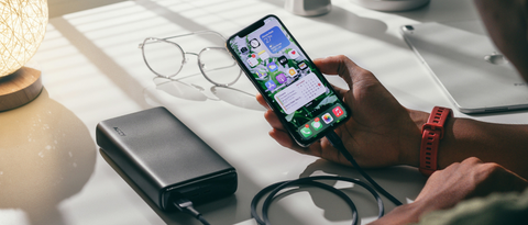 person charging mobile using portable charger