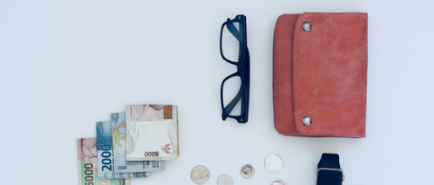 travel wallet with some cash, coins and an eyeglasses