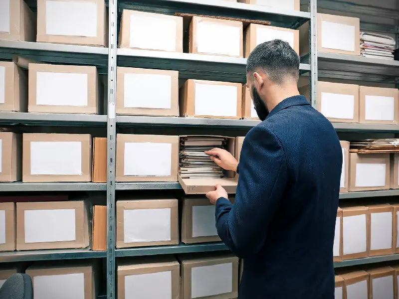 Man Filing a Collection of Old Documents