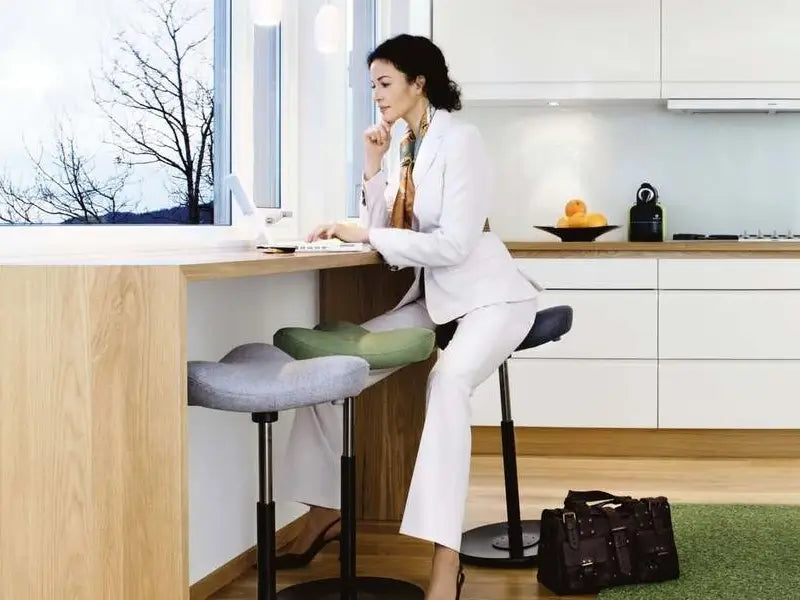Varier Move Sit Stand Stool with User Sitting