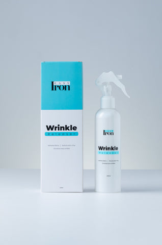 In 3 simple steps, an ironing spray can help you iron your clothes without ironing: just spray, tug and hang!  Lay your clothes or shirts on a flat surface, such as a table or your bed. Then apply the spray across the wrinkled parts.  After you have applied the spray on the wrinkled parts, start tugging the wrinkles with your hands in opposite directions 4-5 times. As you do this, you will start to notice your clothes de wrinkle. Keep repeating the process at the front and back of the shirt and the sleeves.