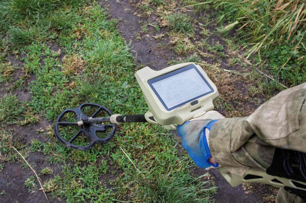 person holding a metal detector