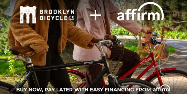 Two people standing next to each other with their bikes, Brooklyn Bicycle Co.'s and Affirm's logo overlaid on image