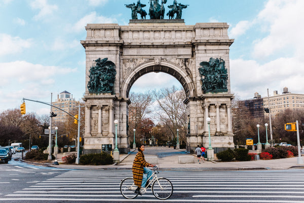 Woman riding ivory step-through bike in Prospect Park