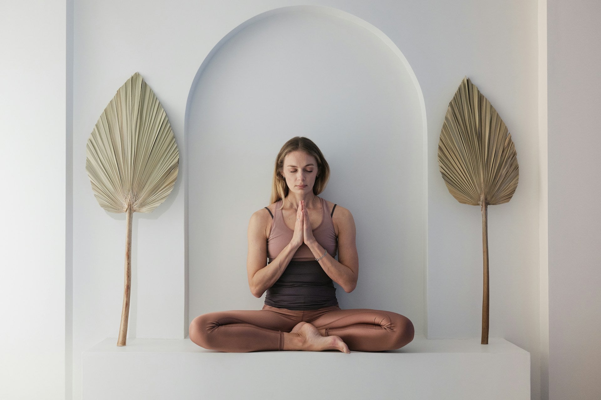 A young blonde woman doing yoga practice. Meditation lotus pose.