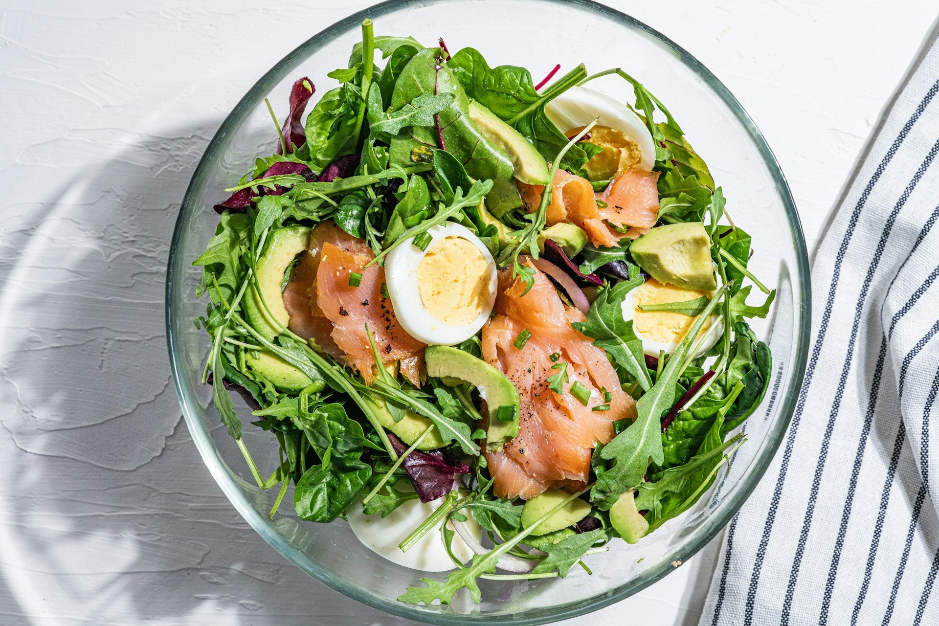A bright green nutrient-rich salad with foods to support a calm central nervous system
