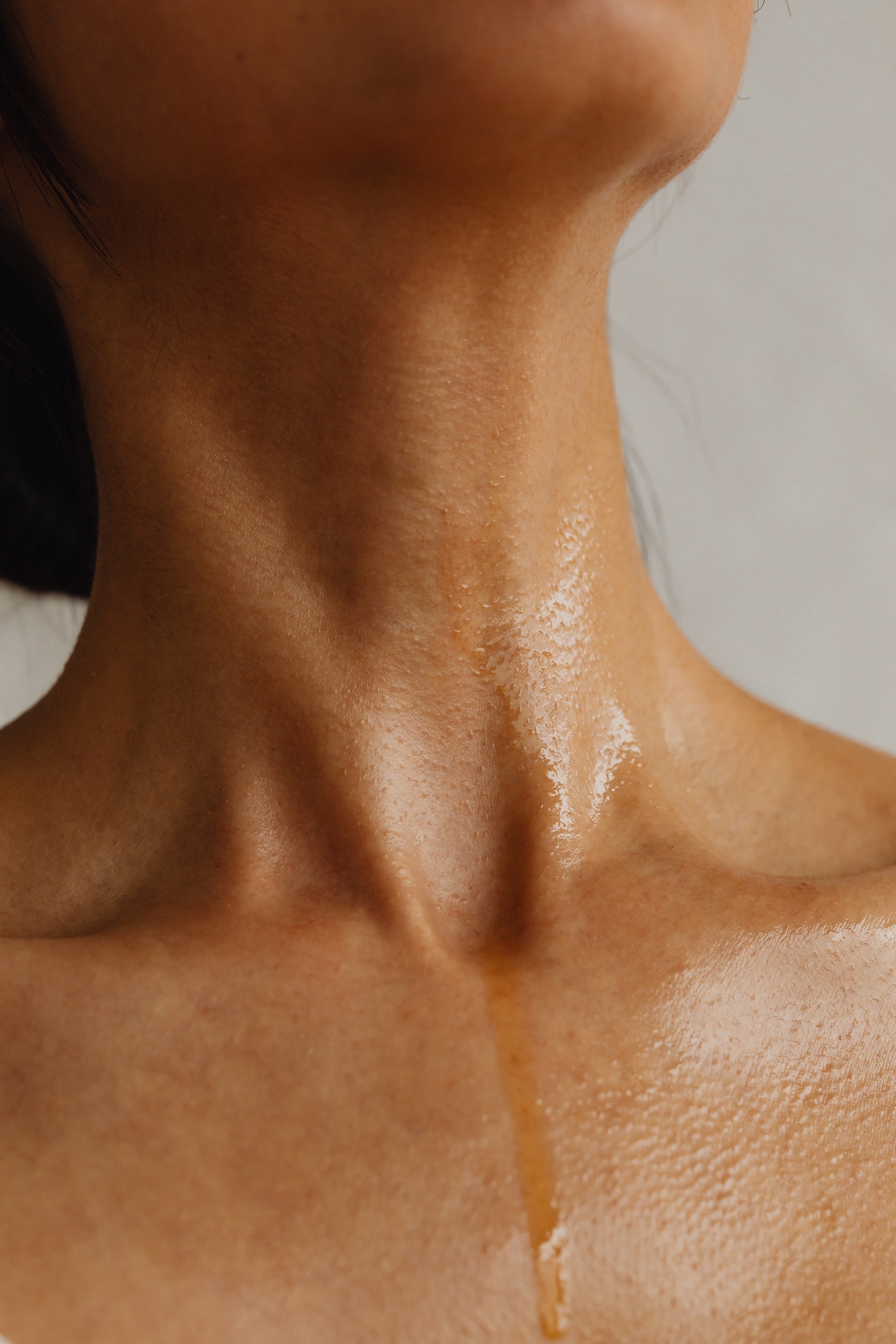 Woman's neck water or body oil