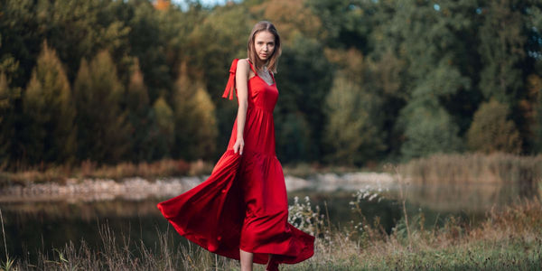 Woman wearing Silk Closet red flowing dress outside