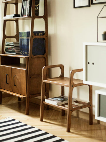 small wooden stool in walnut stain in mid century home