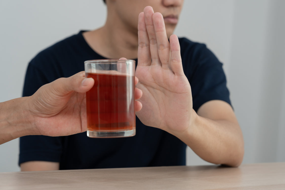 Man refusing alcohol drink to practice mindful drinking