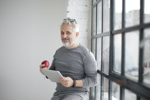 A man eating apple between work