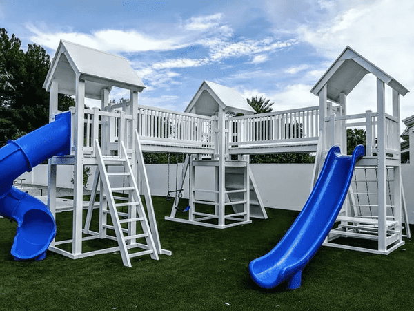 A luxury swing set with blue slides.