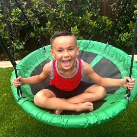 A child on the green gobaplay Round Platform Tree Swing.