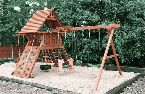 A swing set on sand.