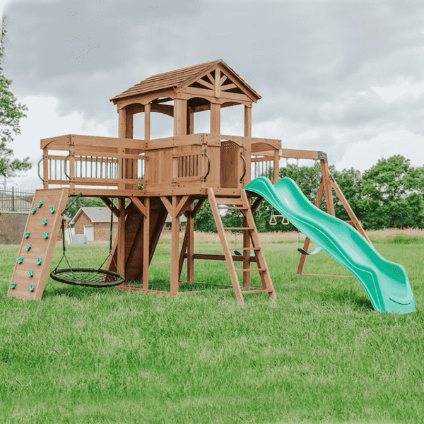 A wooden swing set with multiple features.