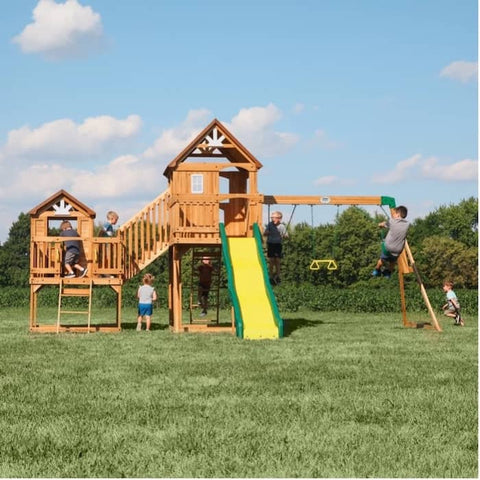 Kids playing on a medium-sized wooden playset.