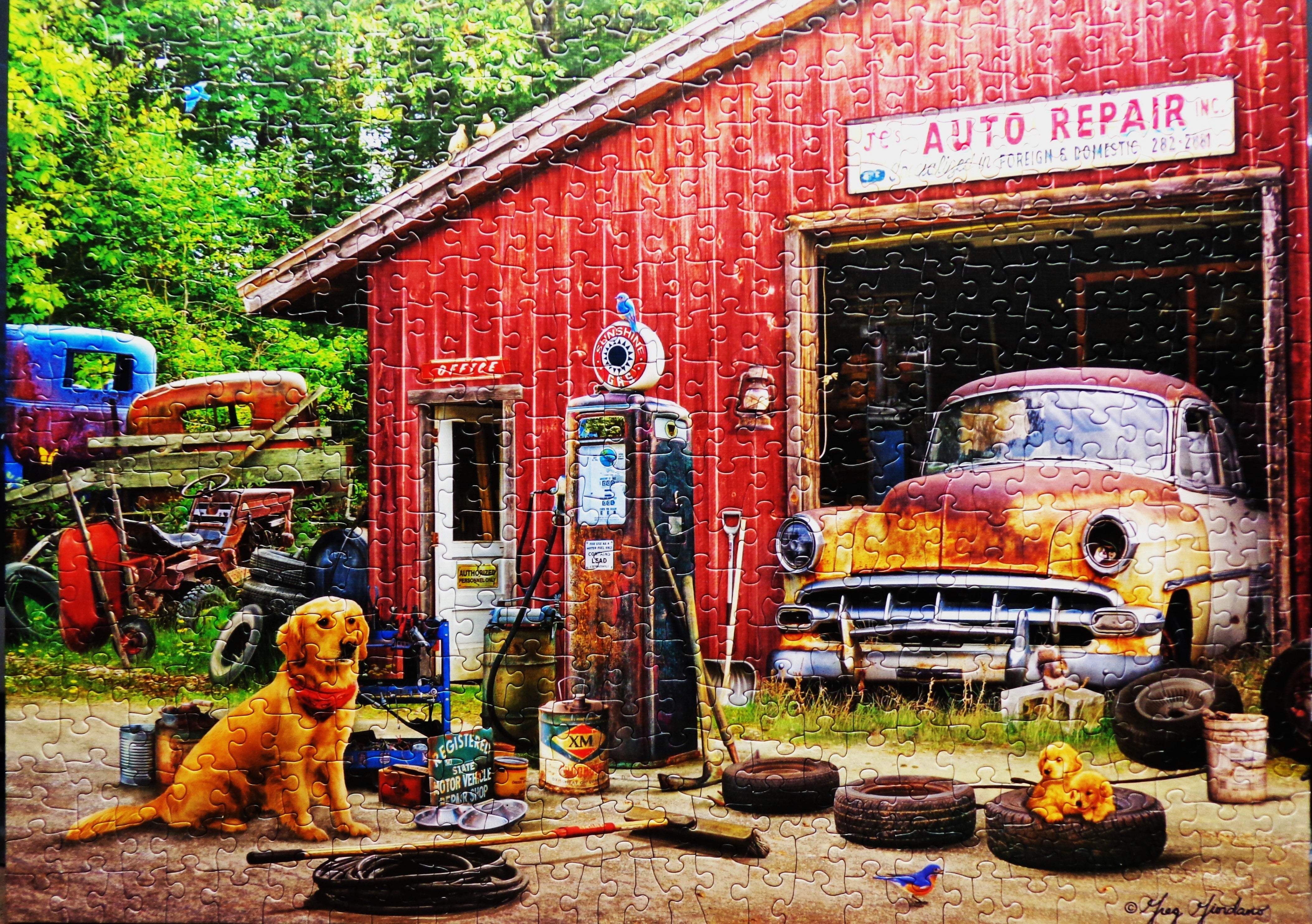 A red auto repair shop with dog by petrol tank