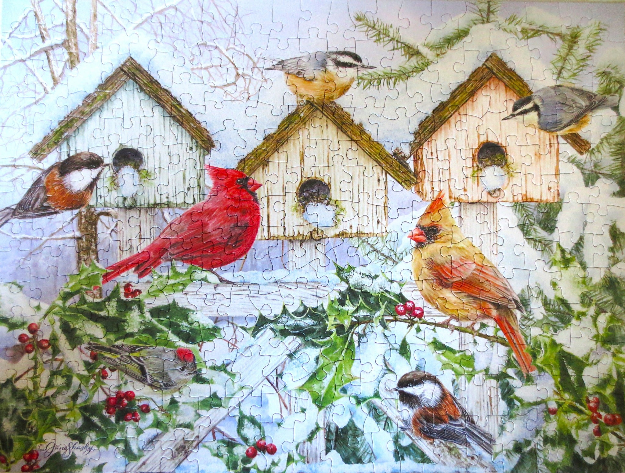 Winter Chorus puzzle with birdhouses and birds in snow and holly