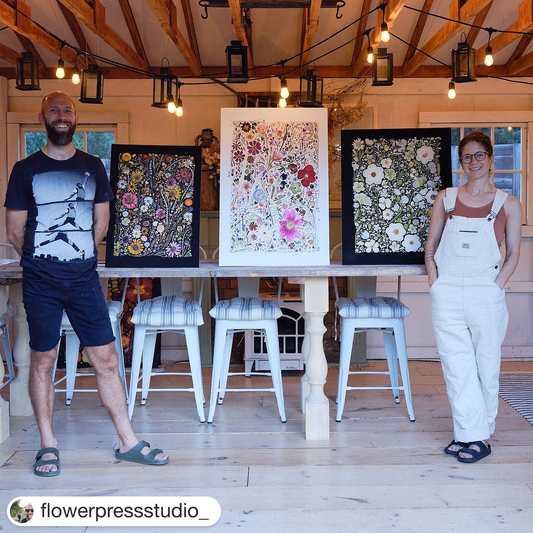 Keith and Rachel standing with their flower pressed artwork