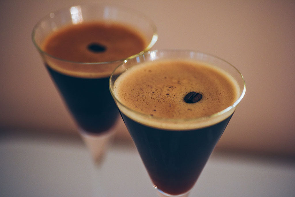 Two espresso martini cocktails garnished with coffee beans