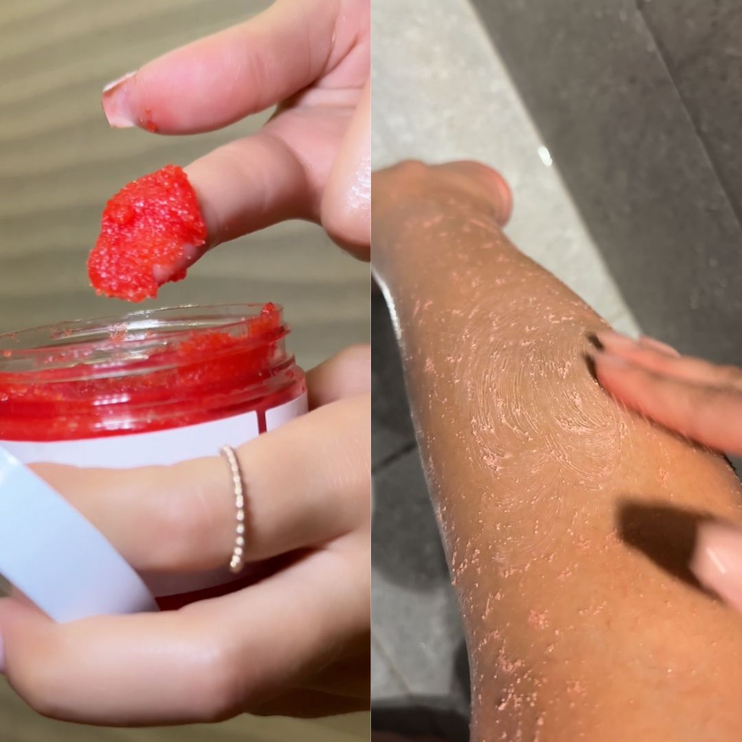Applying red exfoliating scrub to skin from a jar.