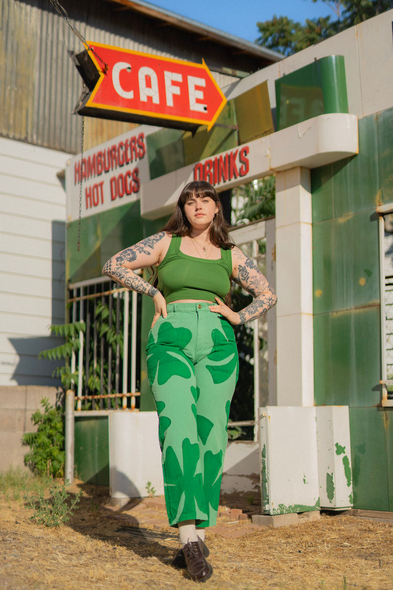 Sydney is wearing Cropped Tank Top in Lawn Green and Icon Work Pants in Clover