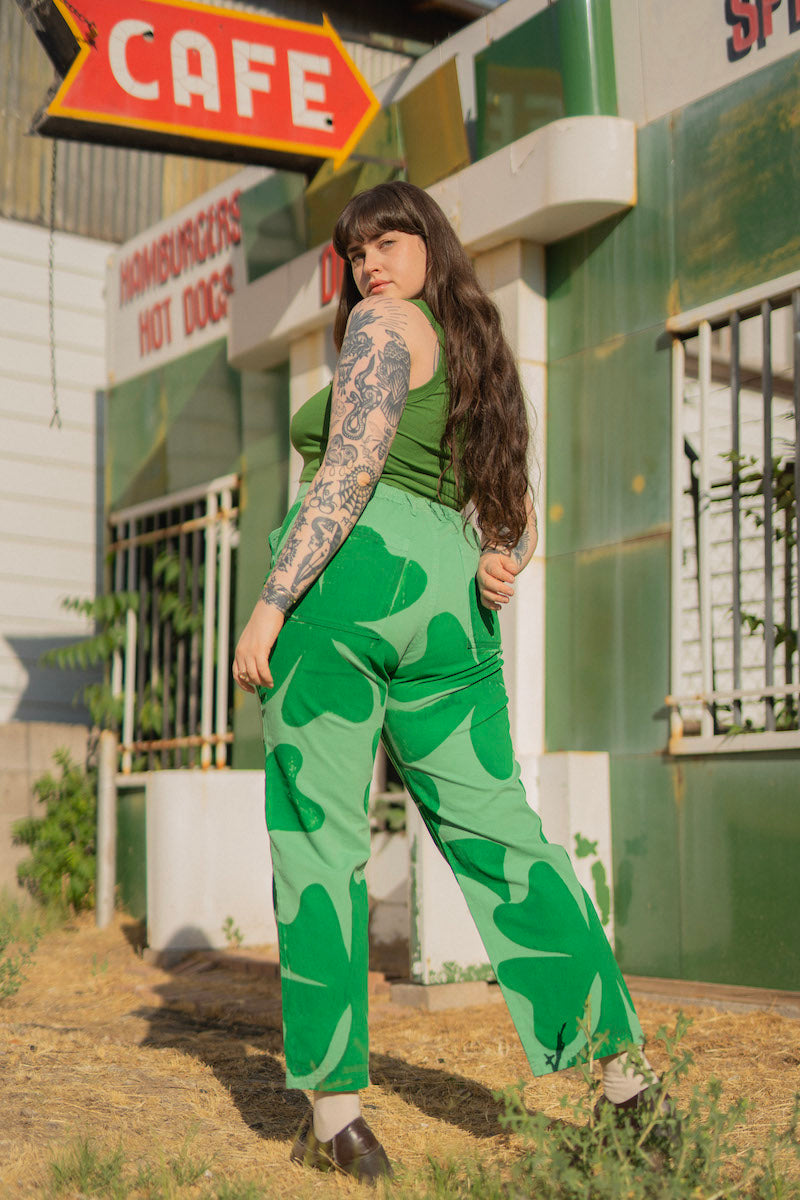 Sydney is wearing Cropped Tank Top in Lawn Green and Icon Work Pants in Clover