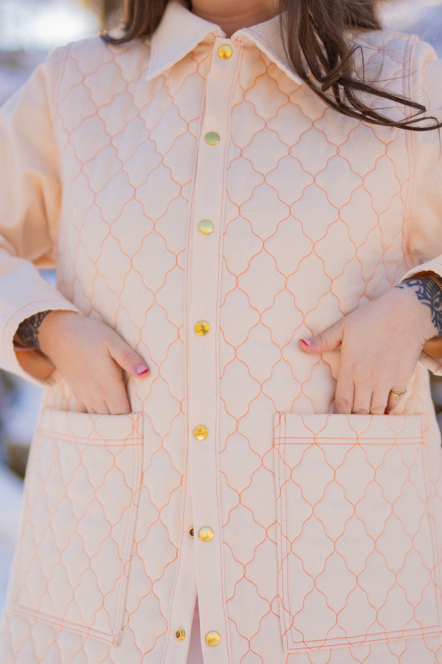 Sydney is wearing Quilted Overcoat in Vintage Off-White, Long Sleeve V-Neck Tee in Vintage Off-White and Bell Bottoms in Vintage Off-White